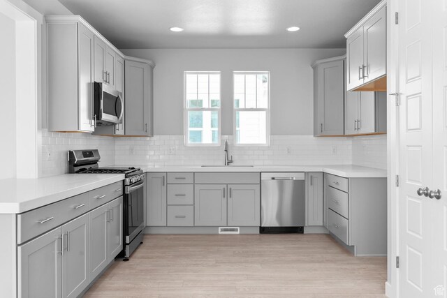 9806 N Willowbank Dr, Highland, UT 84003 - kitchen featuring stainless steel appliances, a sink, gray cabinets, and recessed lighting