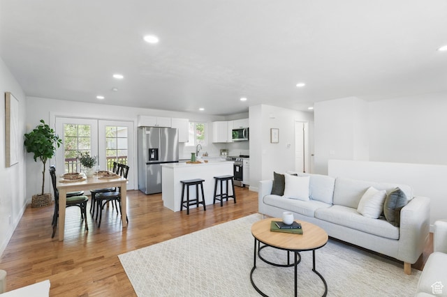 1084 E Bell Canyon Dr, Sandy, UT 84094 - living area with recessed lighting, baseboards, and light wood-type flooring
