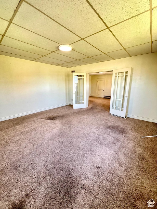 509 E 300 N, Richfield, UT 84701 - unfurnished room featuring a drop ceiling, french doors, baseboards, carpet flooring, and a baseboard heating unit