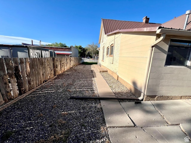 509 E 300 N, Richfield, UT 84701 - view of side of home featuring metal roof and a chimney