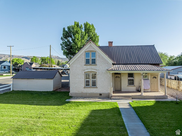 509 E 300 N, Richfield, UT 84701 - view of front of home with brick siding, a porch, a chimney, and metal roof