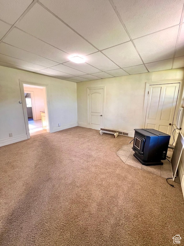 509 E 300 N, Richfield, UT 84701 - below grade area with a wood stove, carpet floors, a paneled ceiling, and baseboards