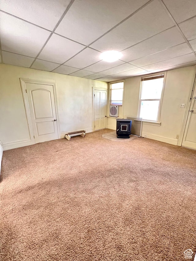 509 E 300 N, Richfield, UT 84701 - spare room featuring a wood stove, a paneled ceiling, carpet, baseboards, and cooling unit