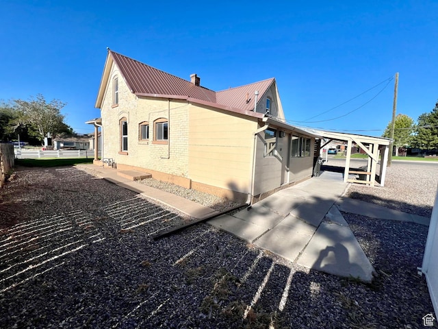 509 E 300 N, Richfield, UT 84701 - view of side of home with metal roof, a chimney, and brick siding