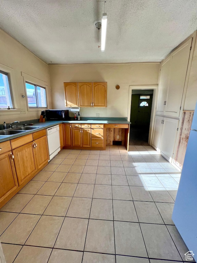 509 E 300 N, Richfield, UT 84701 - kitchen featuring dishwasher, a textured ceiling, light tile patterned floors, and a sink