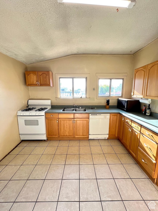 509 E 300 N, Richfield, UT 84701 - kitchen featuring white appliances, a sink, a textured ceiling, plenty of natural light, and vaulted ceiling