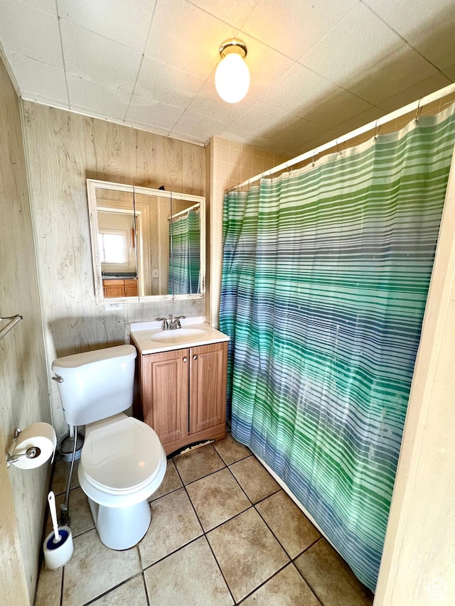 509 E 300 N, Richfield, UT 84701 - full bath featuring vanity, toilet, tile patterned flooring, a shower with shower curtain, and wood walls