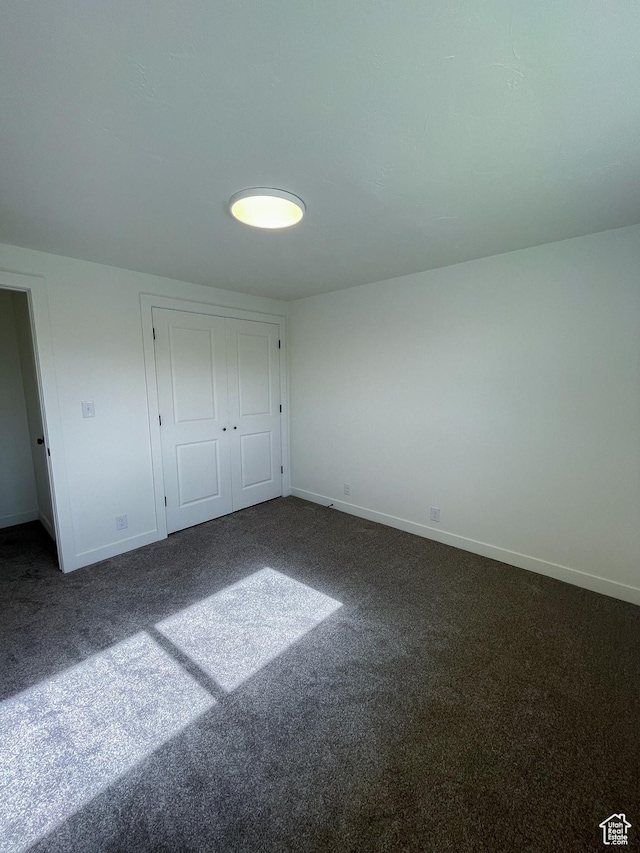 685 S Idaho Ave E, Provo, UT 84606 - unfurnished bedroom with dark carpet, baseboards, and a closet