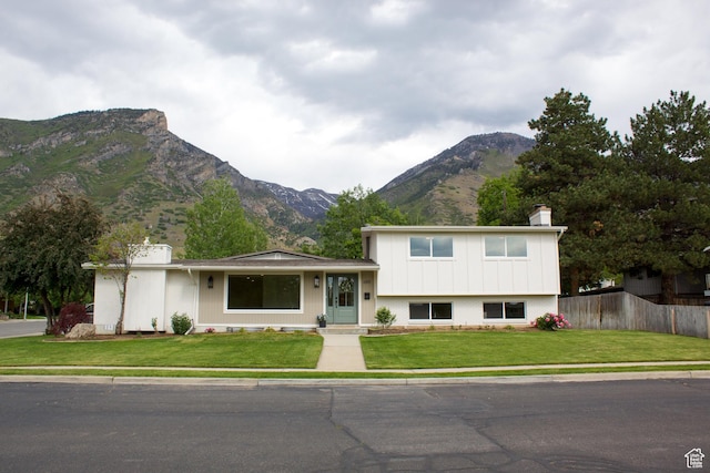 685 S Idaho Ave E, Provo, UT 84606 - split level home featuring a mountain view, a chimney, and board and batten siding