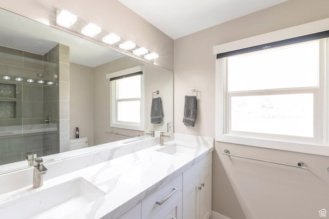 561 N 700 E, Provo, UT 84606 - full bathroom featuring double vanity, tiled shower, and toilet