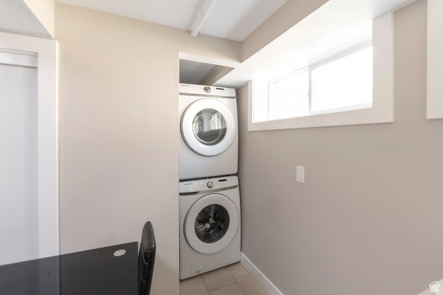 561 N 700 E, Provo, UT 84606 - laundry room featuring stacked washer / dryer, light tile patterned flooring, and baseboards