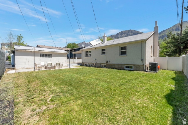 561 N 700 E, Provo, UT 84606 - rear view of property with central air condition unit, a mountain view, a patio, and a chimney
