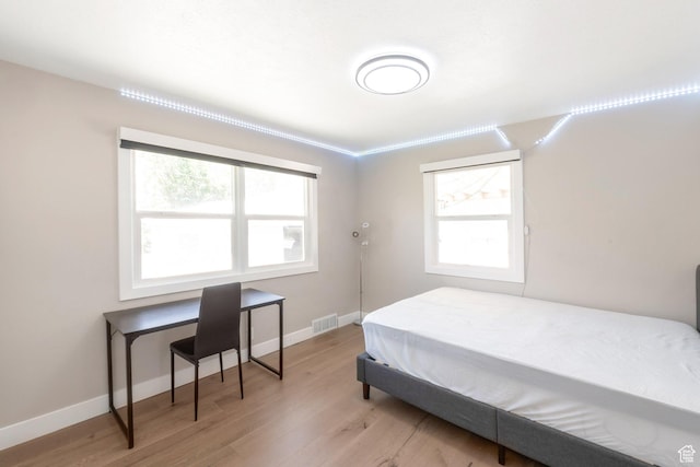 561 N 700 E, Provo, UT 84606 - bedroom with light wood-style floors, multiple windows, and baseboards