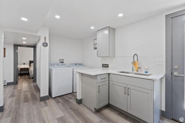 3649 S Hawkeye St, West Valley City, UT 84120 - laundry area with independent washer and dryer, light wood-type flooring, recessed lighting, and cabinet space