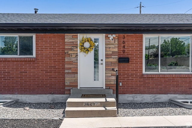 3649 S Hawkeye St, West Valley City, UT 84120 - view of exterior entry with brick siding and a shingled roof