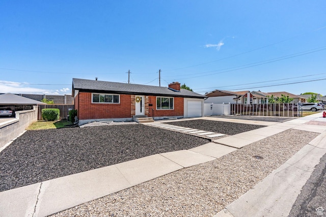 3649 S Hawkeye St, West Valley City, UT 84120 - ranch-style home featuring brick siding, driveway, a chimney, and a garage