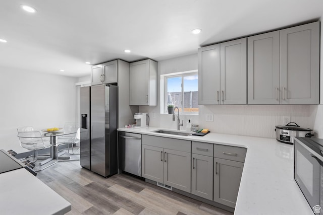3649 S Hawkeye St, West Valley City, UT 84120 - kitchen featuring stainless steel appliances, a sink, gray cabinets, light countertops, and recessed lighting