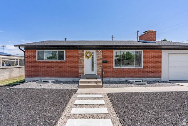 3649 S Hawkeye St, West Valley City, UT 84120 - view of front facade with brick siding, an attached garage, roof with shingles, and a chimney