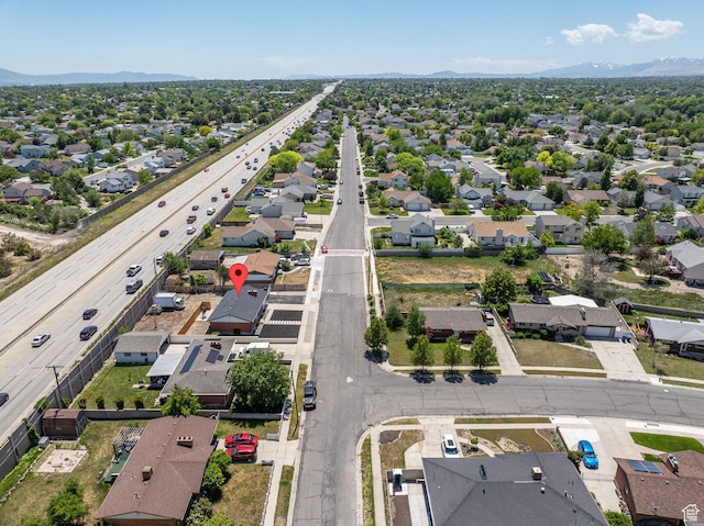 3649 S Hawkeye St, West Valley City, UT 84120 - aerial perspective of suburban area with a major roadway and a mountain backdrop