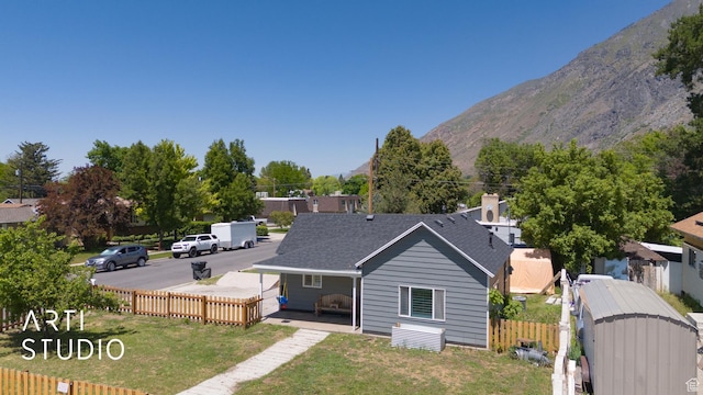 697 E Center St, Springville, UT 84663 - rear view of property with a mountain view and roof with shingles