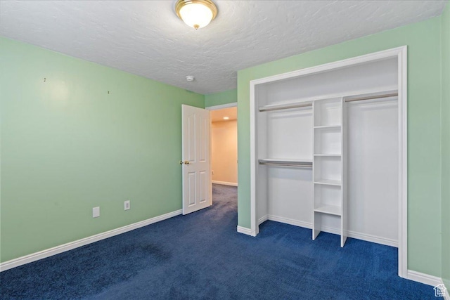 2718 W Southpointe Rd, South Jordan, UT 84095 - unfurnished bedroom with dark colored carpet, baseboards, a textured ceiling, and a closet