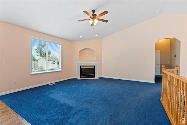 2718 W Southpointe Rd, South Jordan, UT 84095 - unfurnished living room with a ceiling fan, baseboards, a tiled fireplace, and carpet flooring