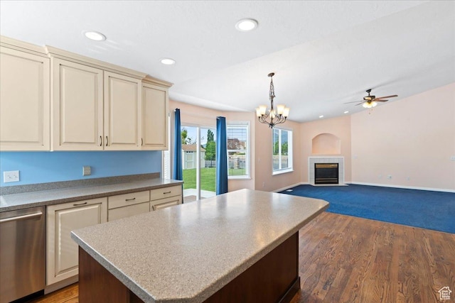 2718 W Southpointe Rd, South Jordan, UT 84095 - kitchen with stainless steel dishwasher, cream cabinetry, a tiled fireplace, a ceiling fan, and a kitchen island
