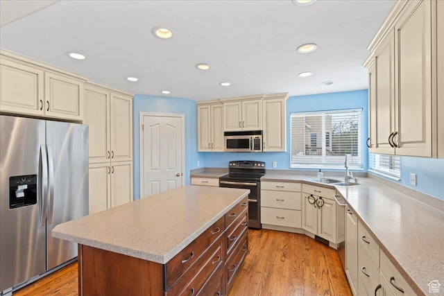2718 W Southpointe Rd, South Jordan, UT 84095 - kitchen with appliances with stainless steel finishes, cream cabinetry, a sink, light countertops, and recessed lighting