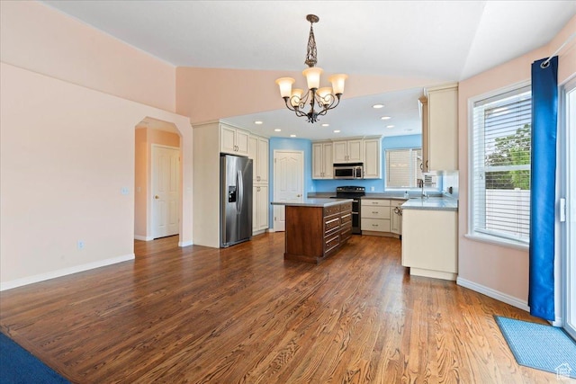 2718 W Southpointe Rd, South Jordan, UT 84095 - kitchen featuring appliances with stainless steel finishes, lofted ceiling, a chandelier, a center island, and dark wood finished floors