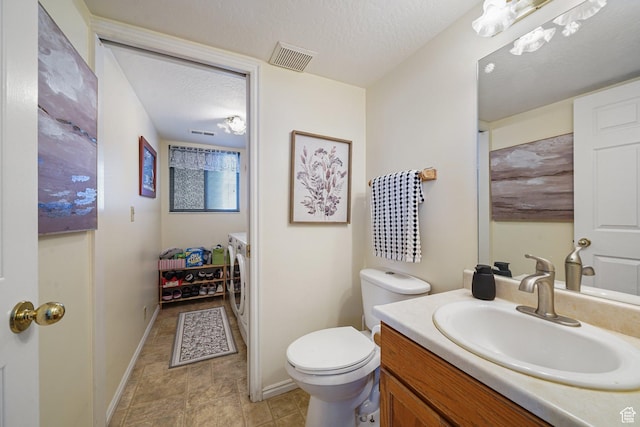 1213 E Earl Way S, Sandy, UT 84094 - bathroom featuring washer and clothes dryer, vanity, toilet, baseboards, and a textured ceiling