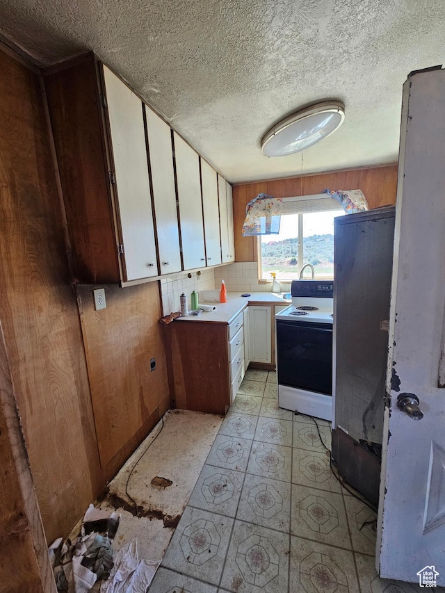 44600 W Hwy 40, Fruitland, UT 84027 - kitchen with electric range, a textured ceiling, white cabinets, light countertops, and light floors
