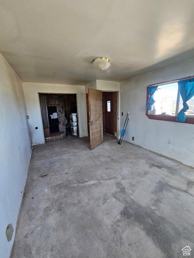 44600 W Hwy 40, Fruitland, UT 84027 - unfurnished living room featuring concrete flooring and a fireplace