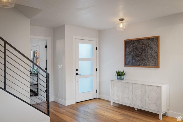 1753 Teal Dr, Kimball Junction, UT 84098 - entrance foyer featuring wood finished floors, stairway, and baseboards