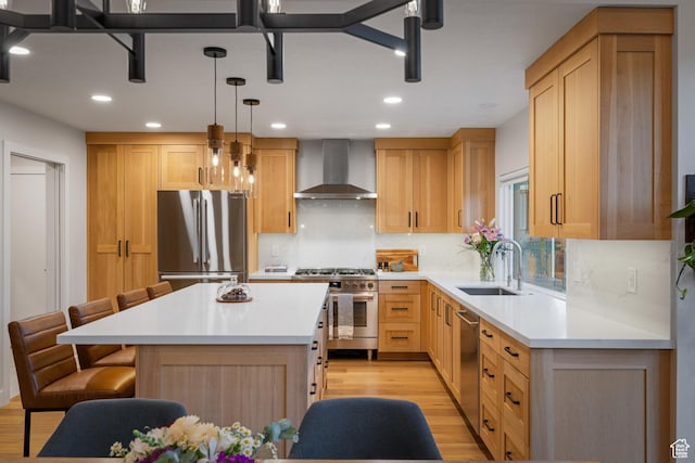 1753 Teal Dr, Kimball Junction, UT 84098 - kitchen with stainless steel appliances, wall chimney exhaust hood, a sink, light wood-style flooring, and a kitchen bar