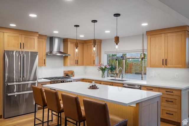 1753 Teal Dr, Kimball Junction, UT 84098 - kitchen featuring stainless steel appliances, wall chimney range hood, a sink, a breakfast bar, and recessed lighting