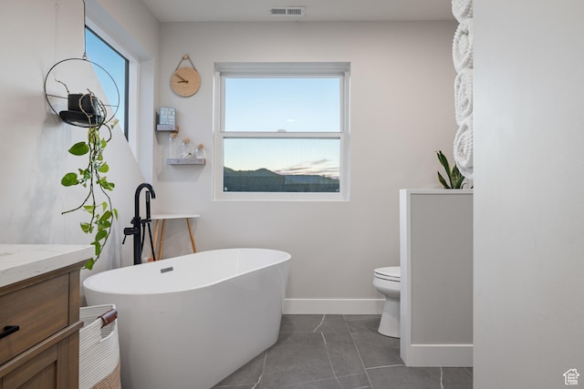 1753 Teal Dr, Kimball Junction, UT 84098 - full bathroom featuring a freestanding bath, vanity, baseboards, and toilet