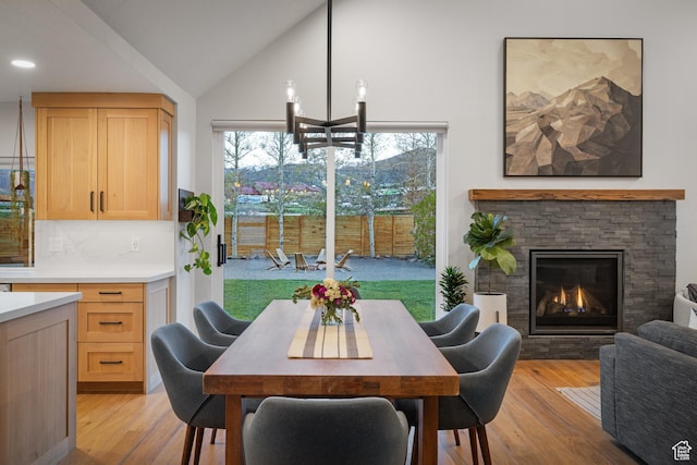 1753 Teal Dr, Kimball Junction, UT 84098 - dining area with high vaulted ceiling, light wood-style floors, and a stone fireplace