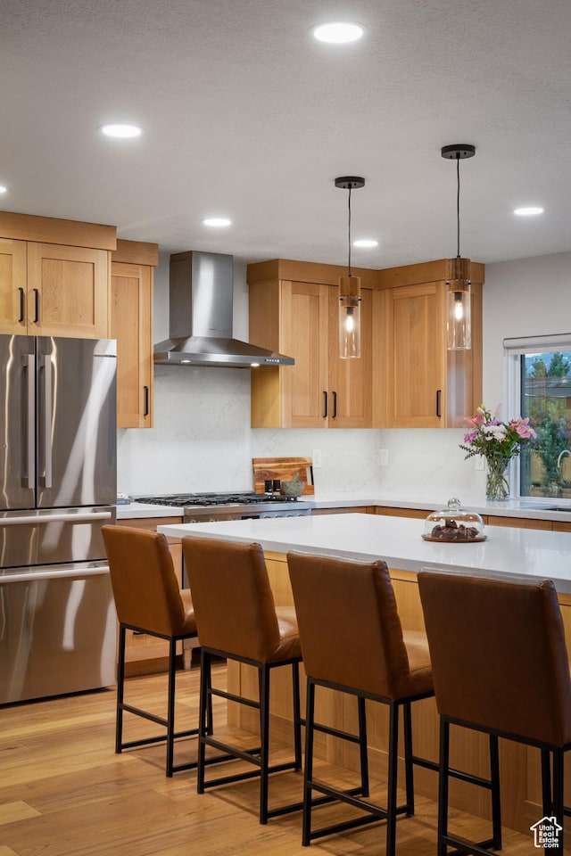 1753 Teal Dr, Kimball Junction, UT 84098 - kitchen with wall chimney range hood, appliances with stainless steel finishes, light countertops, light brown cabinets, and tasteful backsplash