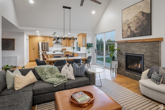 1753 Teal Dr, Kimball Junction, UT 84098 - living area with light wood-type flooring, a stone fireplace, recessed lighting, high vaulted ceiling, and ceiling fan