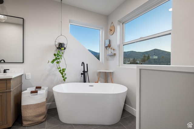 1753 Teal Dr, Kimball Junction, UT 84098 - bathroom featuring vanity, a soaking tub, tile patterned flooring, and baseboards
