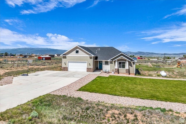 1038 S 4575 W, Cedar City, UT 84720 - view of front facade with a mountain view, concrete driveway, a front yard, and a garage