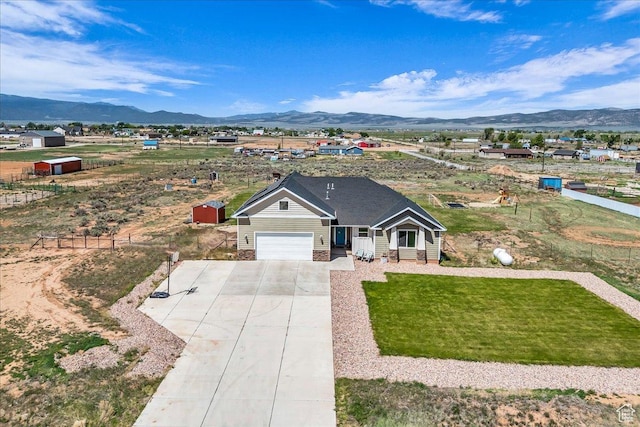1038 S 4575 W, Cedar City, UT 84720 - view of front facade with a mountain view, driveway, an attached garage, and a front yard