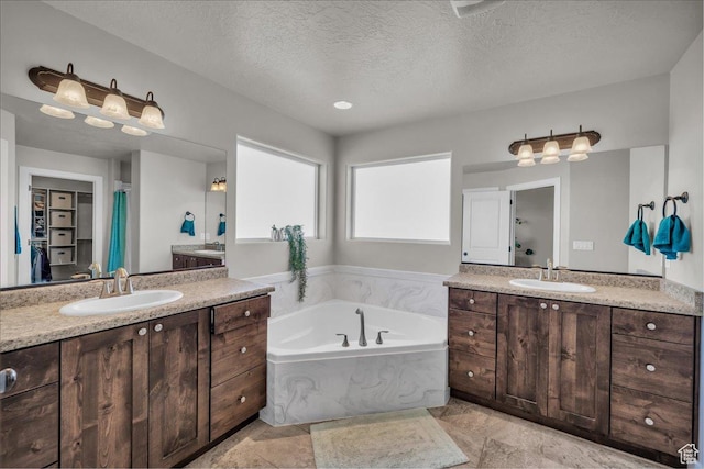 1038 S 4575 W, Cedar City, UT 84720 - bathroom featuring two vanities, a bath, and a textured ceiling