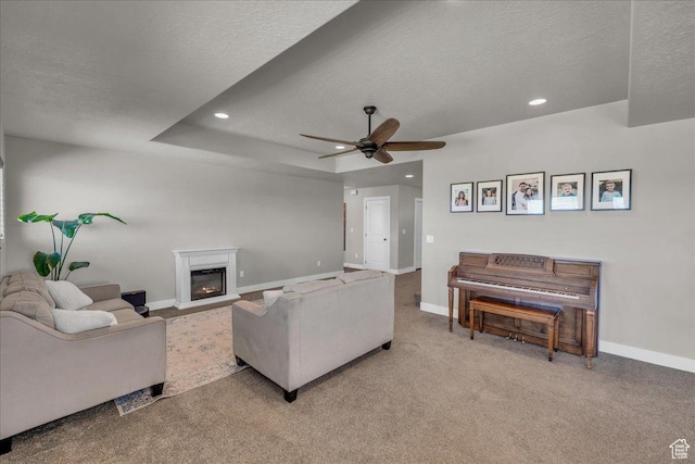 1038 S 4575 W, Cedar City, UT 84720 - living area featuring a textured ceiling, ceiling fan, baseboards, a glass covered fireplace, and light carpet