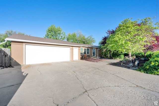 2848 N 2200 W, Salt Lake City, UT 84116 - view of front facade featuring stucco siding, driveway, and an attached garage