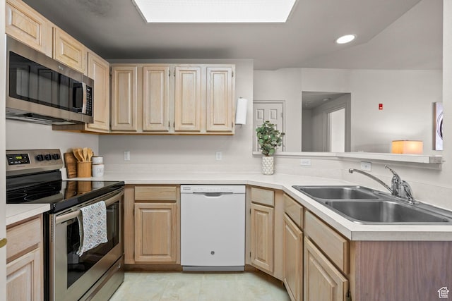 900 Bitner Rd Unit A33, Park City, UT 84098 - kitchen featuring appliances with stainless steel finishes, a sink, light brown cabinetry, light countertops, and a peninsula