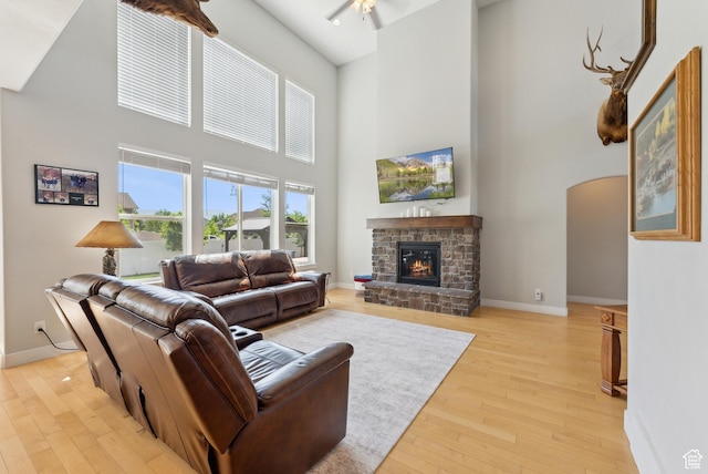 2391 S 330 E, Heber City, UT 84032 - living area featuring a towering ceiling, light wood finished floors, baseboards, arched walkways, and a fireplace