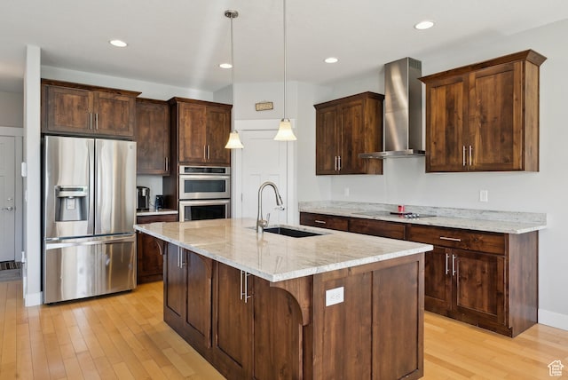 2391 S 330 E, Heber City, UT 84032 - kitchen with stainless steel appliances, wall chimney range hood, a sink, light wood-style floors, and light stone countertops