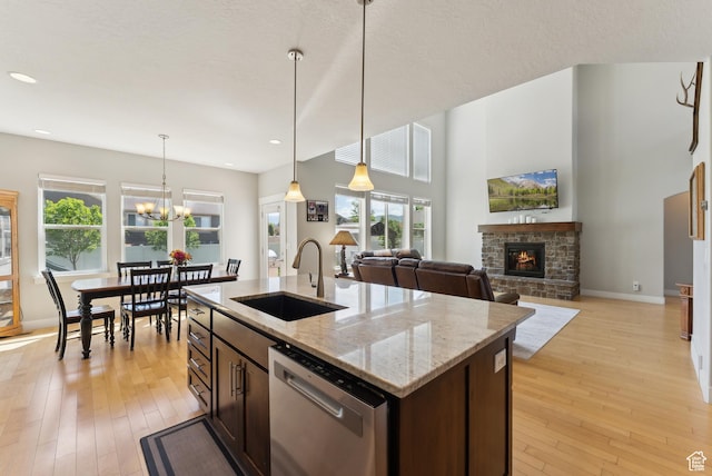 2391 S 330 E, Heber City, UT 84032 - kitchen featuring a sink, dishwasher, dark brown cabinets, a fireplace, and light wood-style flooring