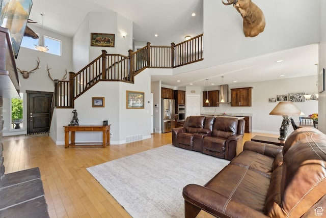 2391 S 330 E, Heber City, UT 84032 - living room featuring a high ceiling, stairway, light wood-type flooring, baseboards, and recessed lighting
